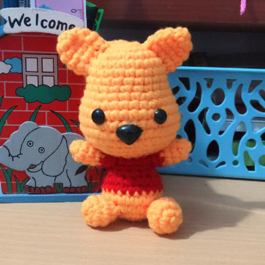 The amigurumi definition is a crocheted or knitted stuffed doll